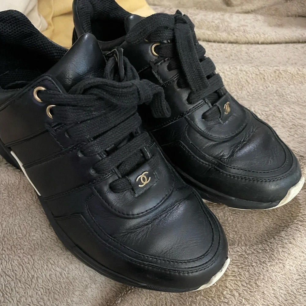 CHANEL Black Leather Low-Top Sneakers with White Accent